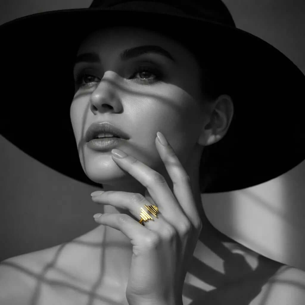 Woman showcasing multiple stylish gold rings and hoop from Ceyrah Ring Collection
