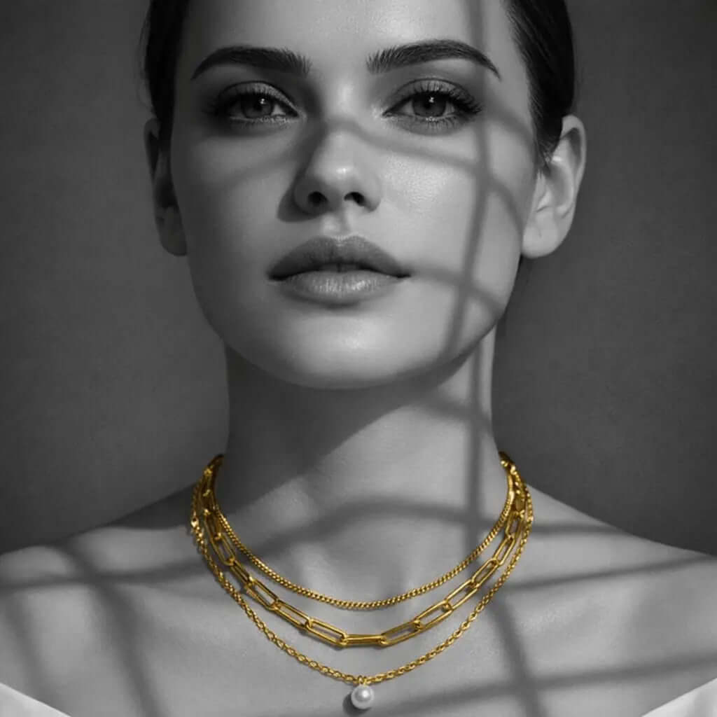 Woman wearing layered gold necklaces and pearl accents, ceyrah necklaces collection