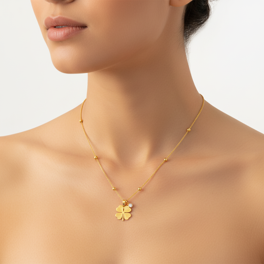 A close-up of a model wearing a Gold Four‑Leaf Clover Pendant Necklace with small gold beads spaced along the chain.