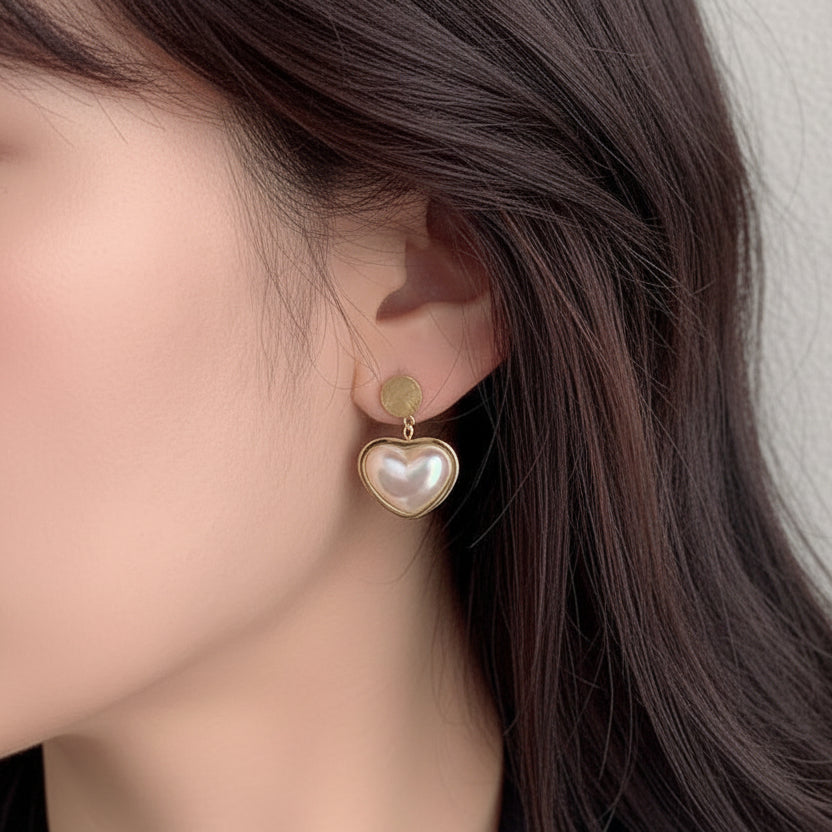 Ceyrah gold heart-shaped pearl drop earrings on model