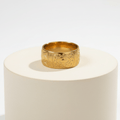 Ceyrah gold ring with engraved geometric and eye motifs on white background