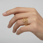 Gold Clover Triple Band Ring shown on a hand, featuring a smooth band, beaded detail, and a geometric clover design.