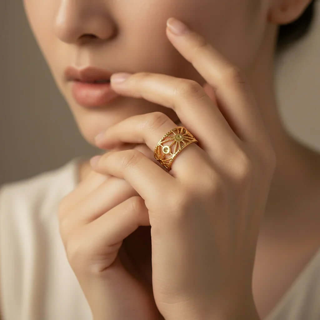 Gold Cut Out Floral Ring worn elegantly on a woman's hand showcasing intricate detailing and modern design.