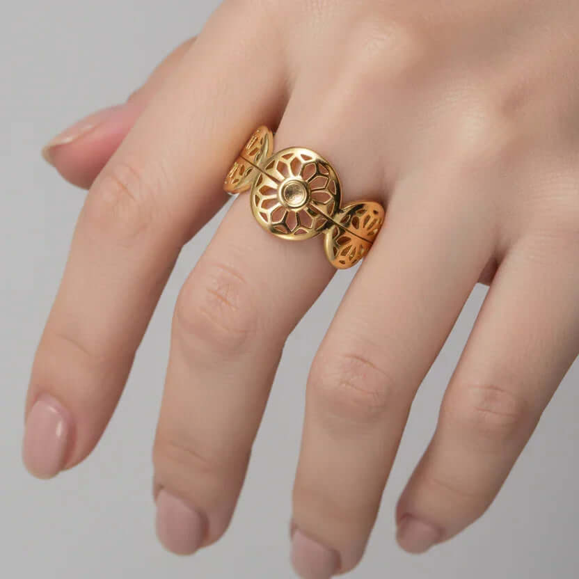 Gold Floral Leaf Cut Out Ring displayed on a hand with delicate floral cut-outs, showcasing its elegant design.