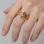 Gold Floral Leaf Cut Out Ring displayed on a hand with delicate floral cut-outs, showcasing its elegant design.