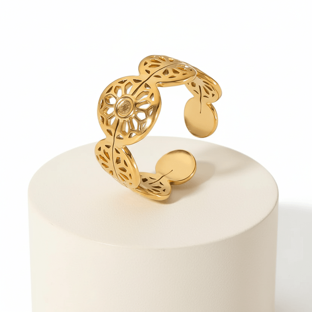 Gold Floral Leaf Cut Out Ring displayed on a pedestal showcasing its intricate floral design and open silhouette.