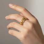 Hand wearing Ceyrah gold leaf design ring, elegant minimalist jewelry