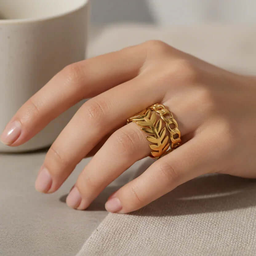 Gold Leaf & Chain Adjustable Ring worn on a hand, showcasing its elegant dual-motif design.