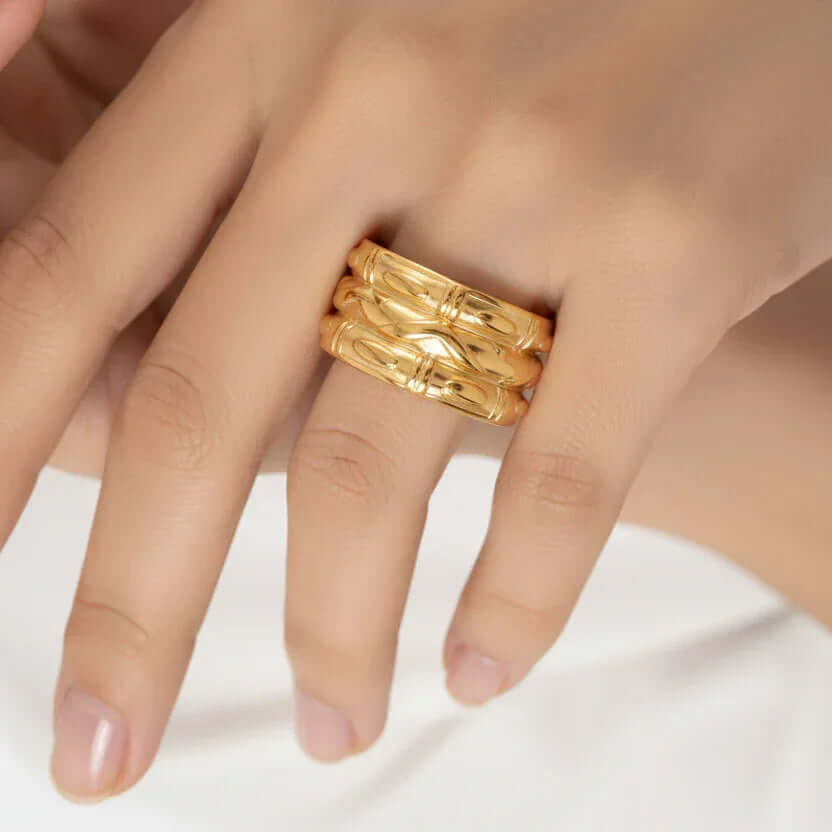 Ceyrah gold stackable rings with engraved design on hand