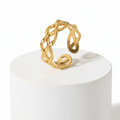 Ceyrah gold open cuff ring with intricate braided design on white background