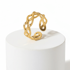 Ceyrah gold open cuff ring with intricate braided design on white background