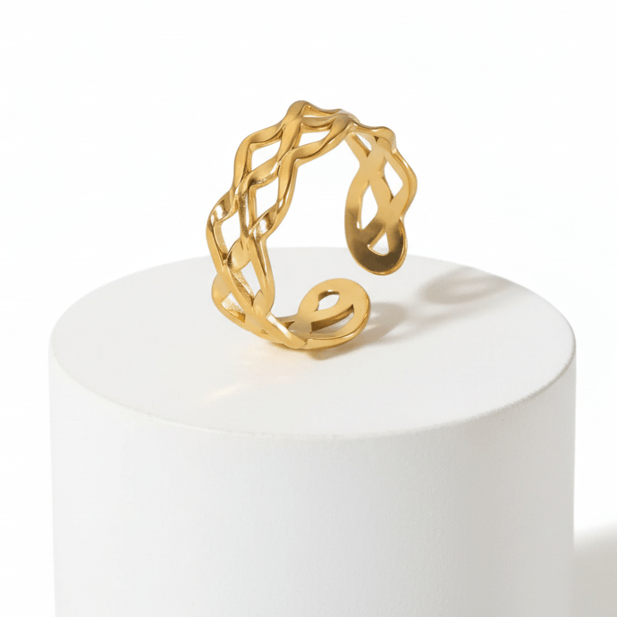 Ceyrah gold open cuff ring with intricate braided design on white background