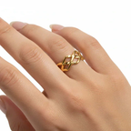 Ceyrah gold braided ring on hand, elegant jewelry against white background
