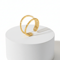 Gold Double Band Open Ring displayed on a round pedestal showcasing its minimalist design.