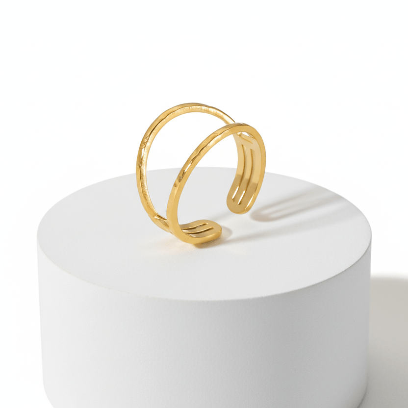 Gold Double Band Open Ring displayed on a round pedestal showcasing its minimalist design.