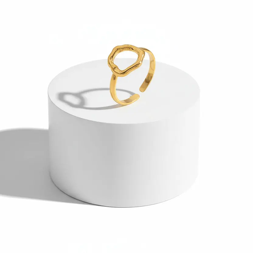 Gold Abstract Open Form Ring displayed on a white pedestal showcasing its unique, sculptural design.