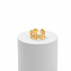 Gold Floral Linked Ring displayed on a pedestal, showcasing its delicate floral design and golden finish.