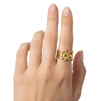 Gold Floral Linked Ring displayed on a hand with a delicate design featuring sculpted flowers.