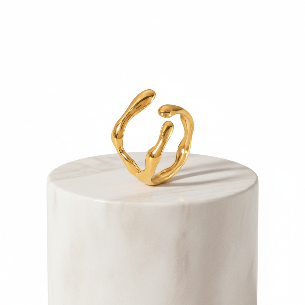 Gold Organic Sculpted Ring on a marble pedestal, showcasing its artistic and modern silhouette.