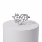 Silver Branch Leaf Adjustable Ring displayed on a white pedestal with elegant leaf design.