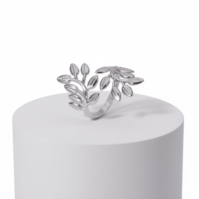 Silver Branch Leaf Adjustable Ring displayed on a white pedestal with elegant leaf design.