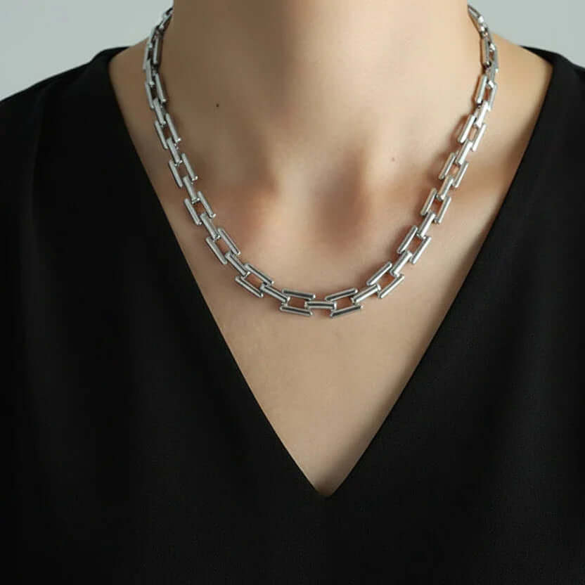 Rectangular Link Chain Necklace showcasing a modern silver design on a person, perfect for layering or solo wear.