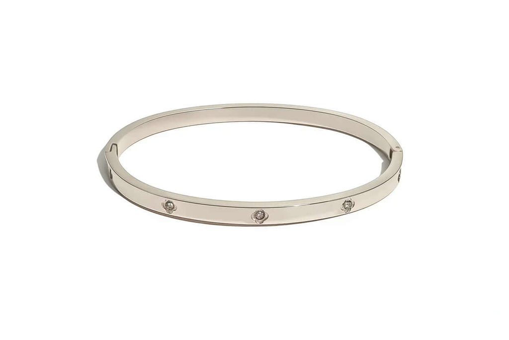 Ceyrah silver bangle bracelet with round diamond accents on white background
