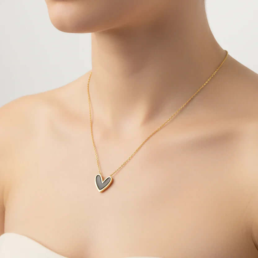 Gold chain heart pendant necklace on model, Ceyrah jewelry, elegant minimalist style