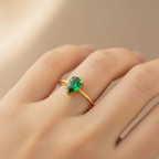 Gold ring with pear-shaped green gemstone on hand, Ceyrah jewelry