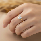 Gold ring with pear-shaped gemstone on hand, Ceyrah jewelry product close-up