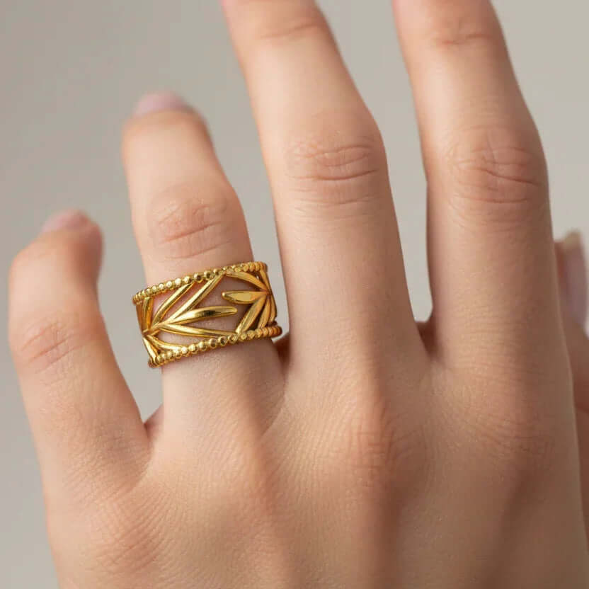 Leaf Etched Adjustable Ring showcased on a hand, featuring intricate leaf etching and a beaded edge design.