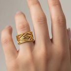 Leaf Etched Adjustable Ring showcased on a hand, featuring intricate leaf etching and a beaded edge design.