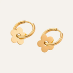 Ceyrah gold hoop earrings with flower-shaped charms on light background