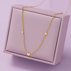 Gold heart pendant necklace displayed on a light purple jewelry box, Ceyrah jewelry