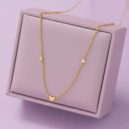 Gold heart pendant necklace displayed on a light purple jewelry box, Ceyrah jewelry