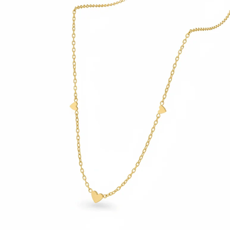 Ceyrah gold chain necklace with three small heart charms on white background