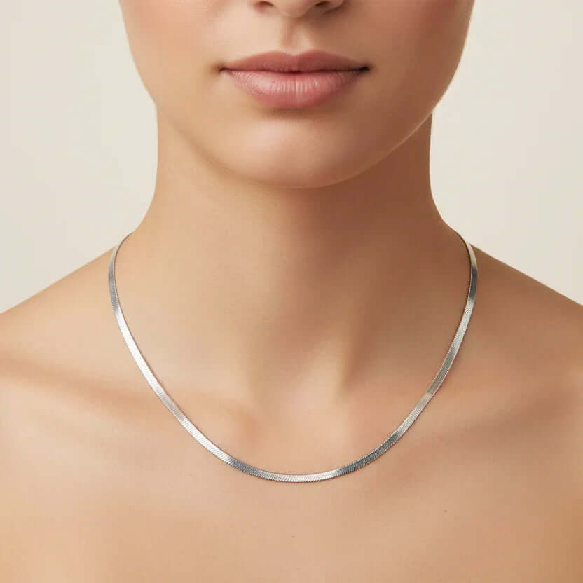 Ceyrah sleek silver herringbone chain necklace on model's neck
