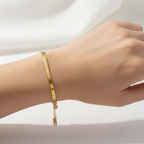 Ceyrah minimalist gold bracelet on wrist, elegant jewelry against white background