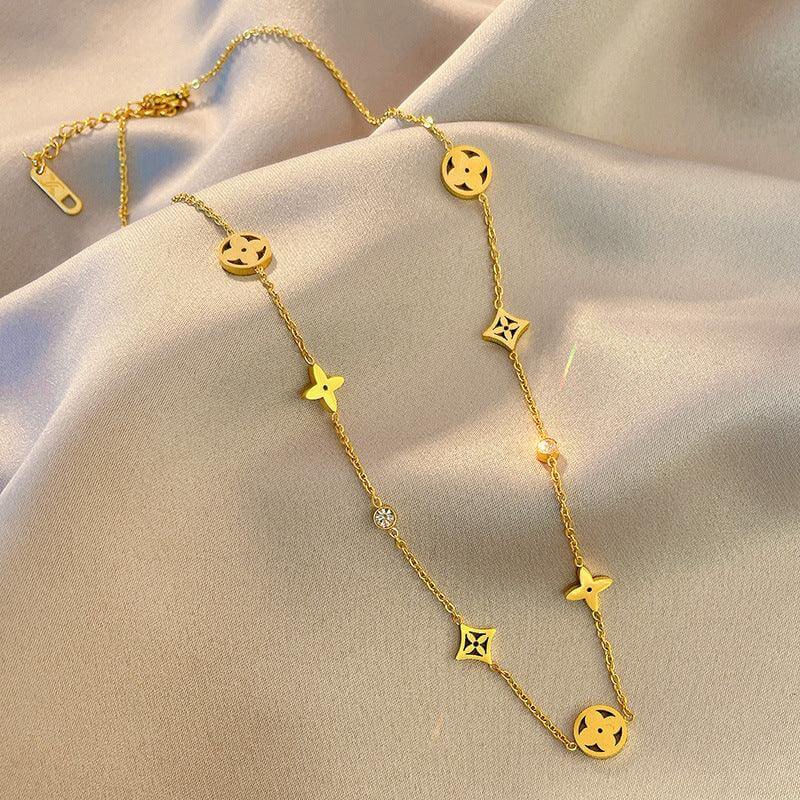 Gold fashion necklace with geometric charms on beige satin, Ceyrah jewelry accessory