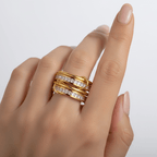 Four Layered Gold Eternity Ring showcased on a hand, featuring polished gold bands and sparkling square-cut stones.