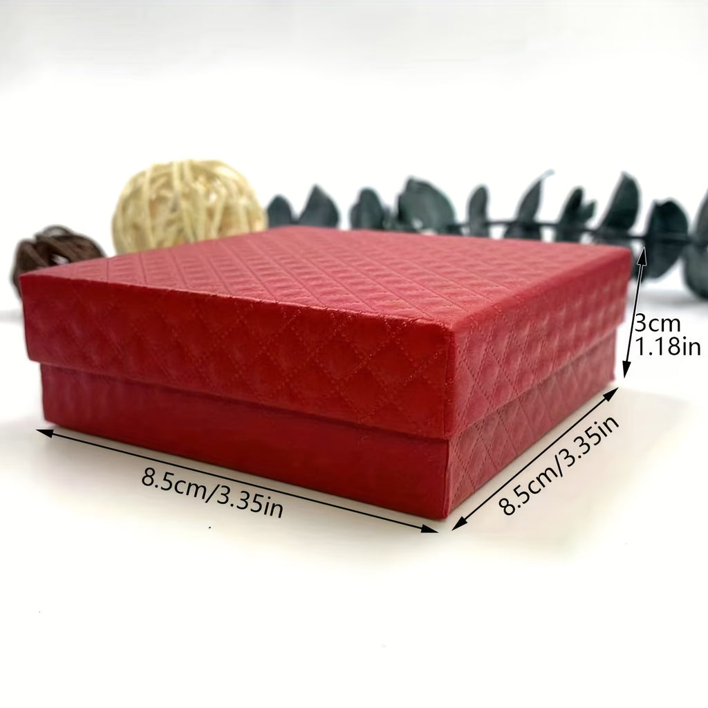 Red Gift box with necklace on a white surface with decorative elements in the background