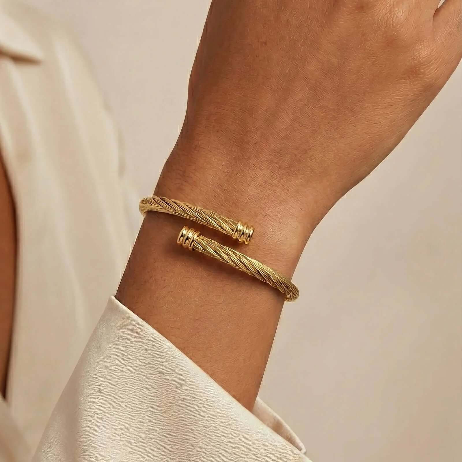 Elegant gold twisted cuff bracelet on wrist, Ceyrah jewelry collection