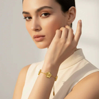 Five Leaf Clover Bracelet worn by a model, featuring a delicate gold charm and adjustable chain.