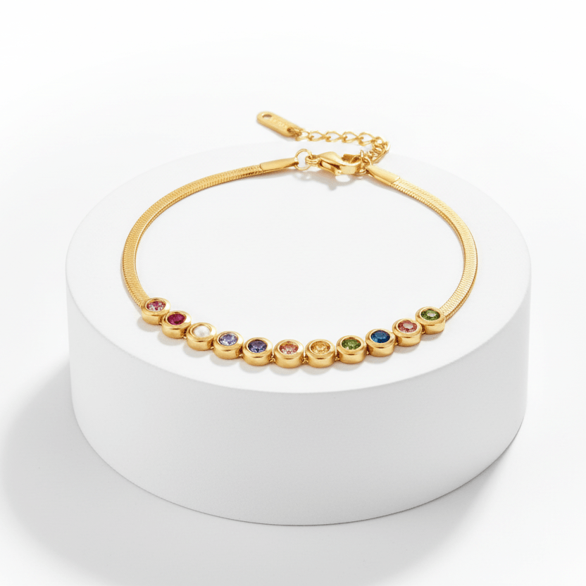 Ceyrah gold bracelet with colorful gemstones, adjustable chain, on white pedestal