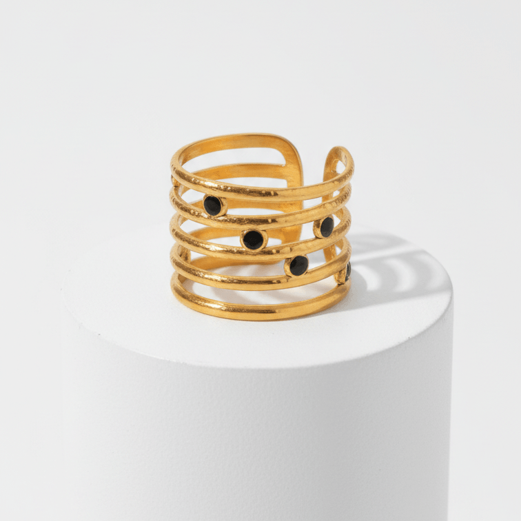 Astra Five‑Band Black Stone Adjustable Ring on a white pedestal against a light gray background