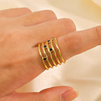 Astra Five‑Band Black Stone Adjustable Ring on a hand against a beige background