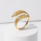 Aurelia Leaf Adjustable Gold Ring on a white pedestal with a white background