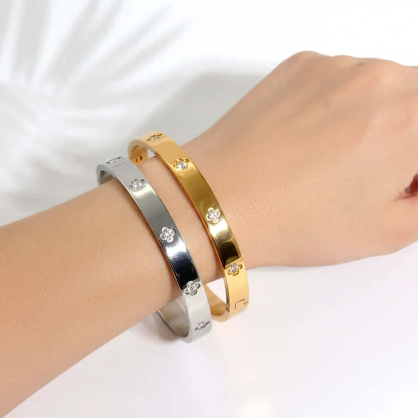Ceyrah gold and silver Big Clover Crystal Bangle Bracelet on wrist, reflective finish, elegant design