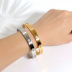 Ceyrah gold and silver Big Clover Crystal Bangle Bracelet on wrist, reflective finish, elegant design