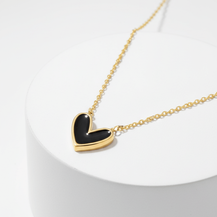 Black Heart Necklace Gold necklace with a black heart pendant on a white background
